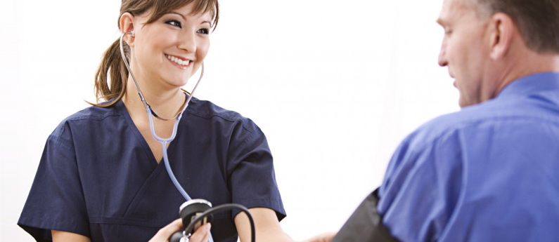 Nurse taking a patient's blood pressure.