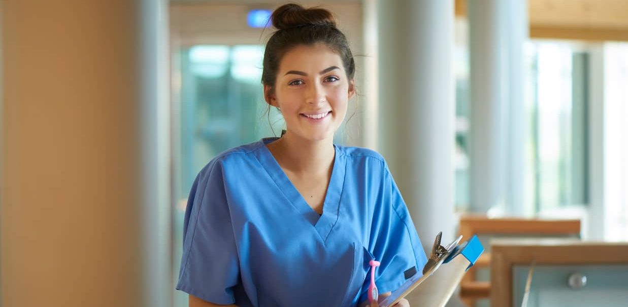 Woman in scrubs with clipboard