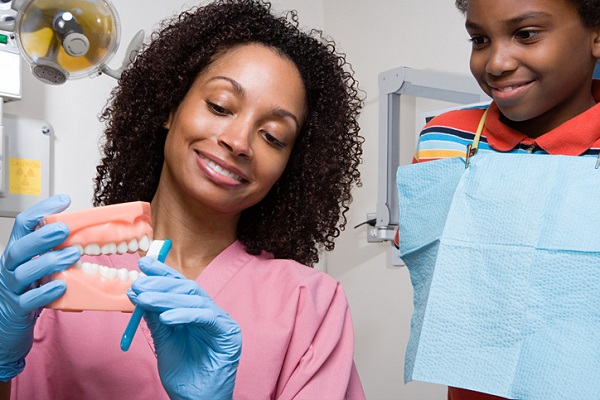 Help patients avoid cavities when you become a dental assistant by encouraging them to brush regularly