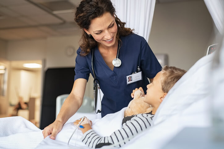 Practical nurse taking care of a child in a hospital after practical nurse training