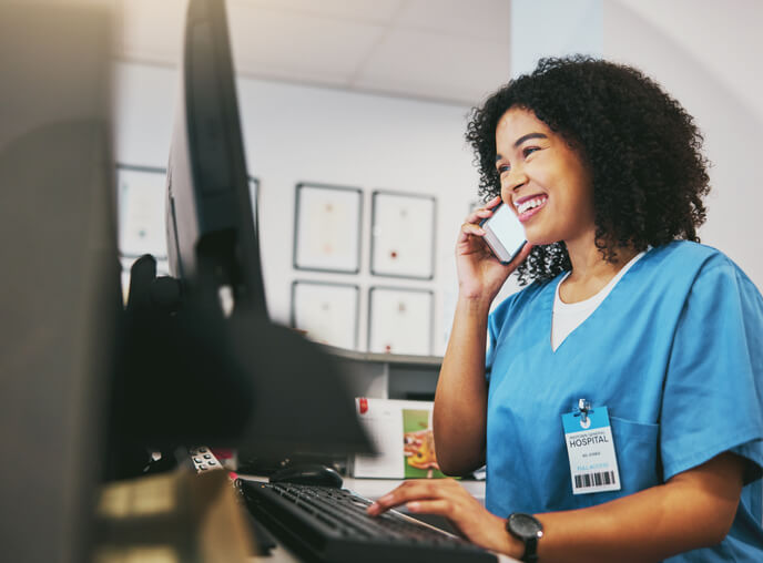 A smiling female dental receptionist in an office after completing her dental reception training