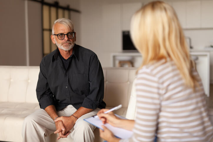 A mental health worker counselling an older client