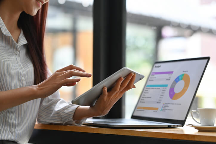 A digital marketing training grad reviewing analytics on a tablet