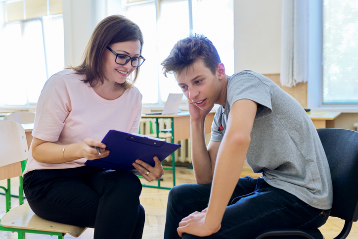 A social service worker training grad talking to a client