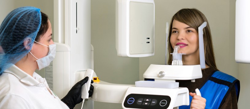 Dental Imaging professional performing a dental x-ray on patient.