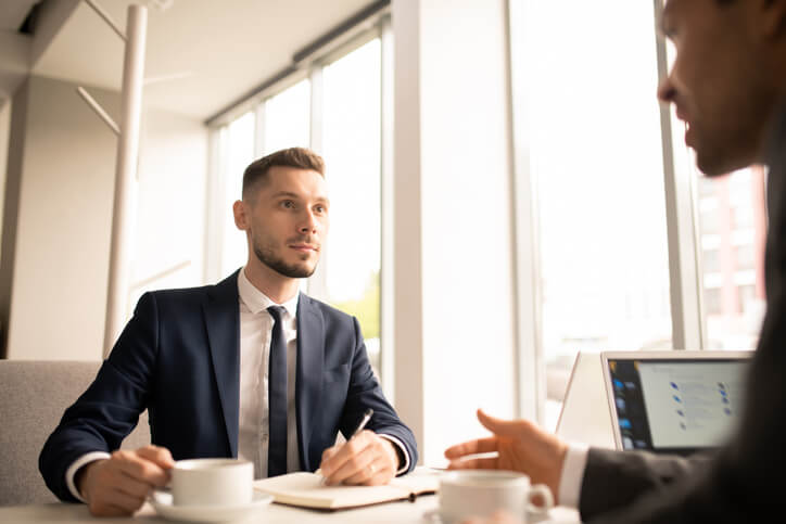 A business office management training grad in a one-on-one client meeting