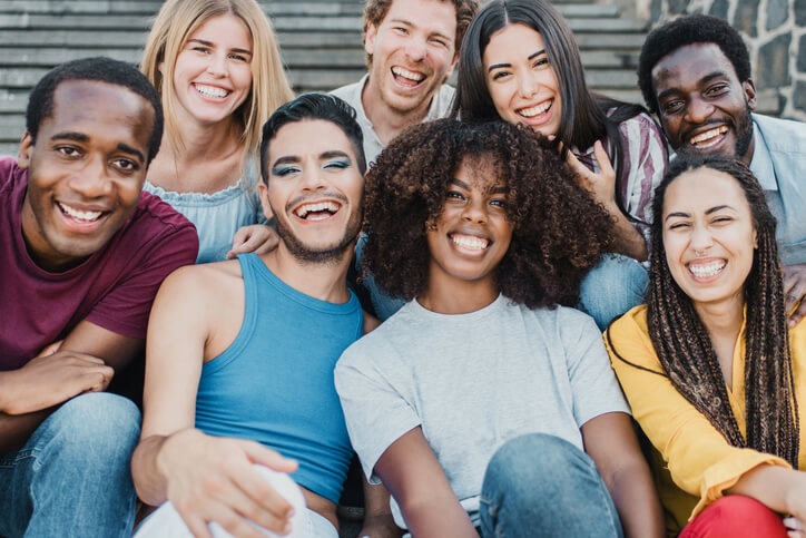 A group of smiling social service workers taking a group photo after their career training