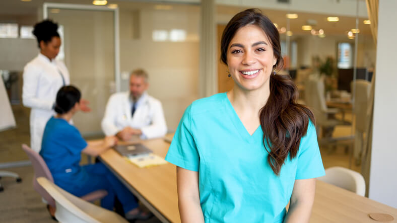 A healthcare assistant training grad in a professional meeting