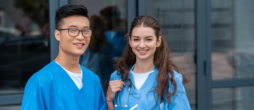 Health Care Assistant English as a Second students outside of a medical building.