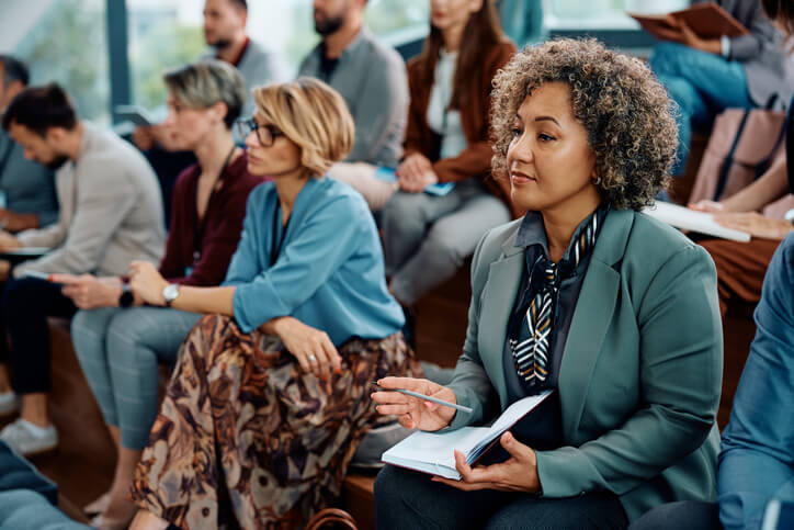 A businesswoman taking notes in a career training class