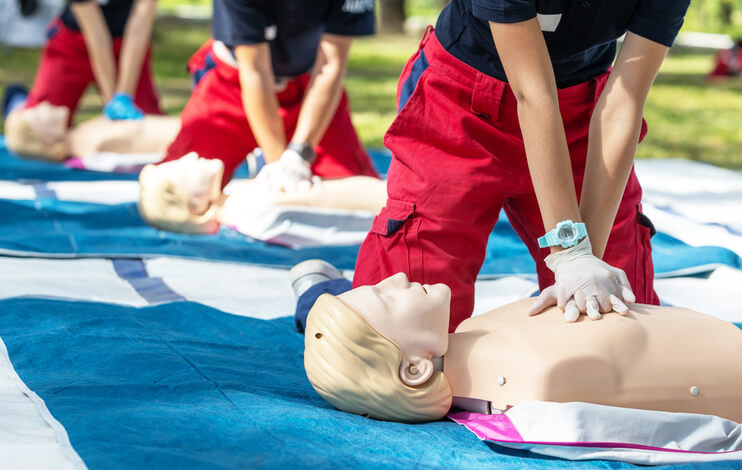 A class of budding healthcare workers learning CPR techniques in career training 