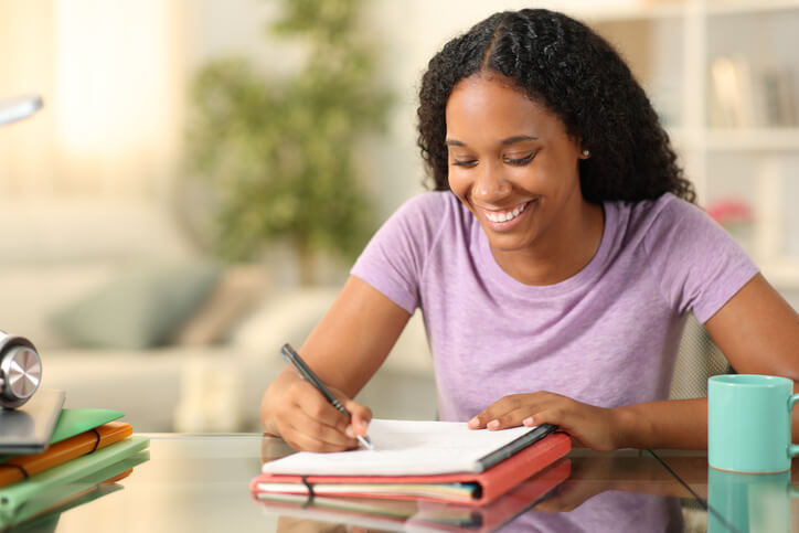 A female career training student writing in her notebook and setting academic goals