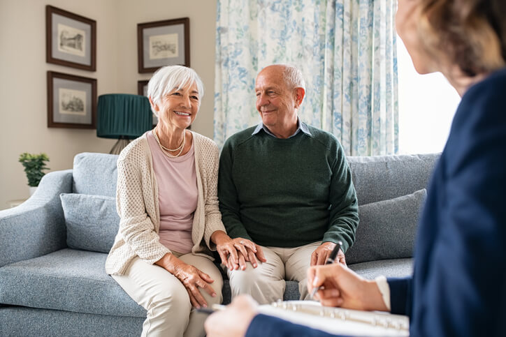 An experienced community support worker interacting with a married couple after completing her community support worker training