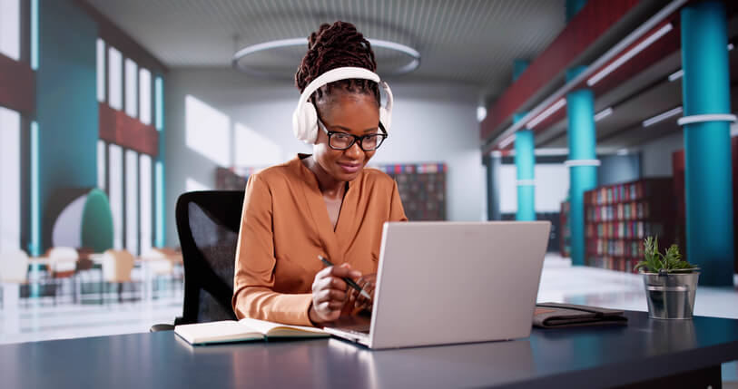 A female digital marketing professional working on a laptop at home after completing her digital marketing training