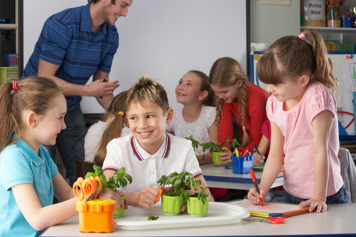 A group of students and an education assistant during a learning activity