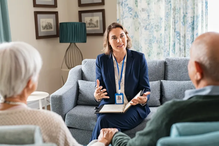 A community Support Worker training graduate guiding a patient in a supportive living environment