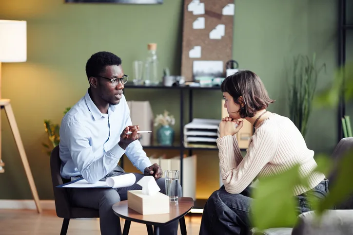 A community Support Worker training graduate assisting a client during a daily activity