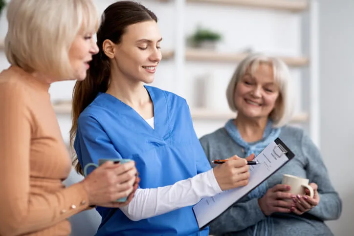 A health care assistant updating family members on client progress