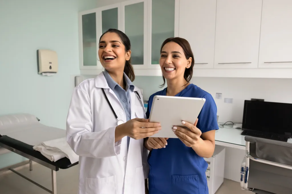 Nurse collaborating with a health care assistant in a care facility
