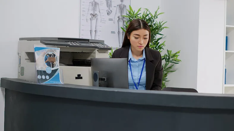A student practicing front-desk administrative skills, an example of what to expect when you become a dental receptionist