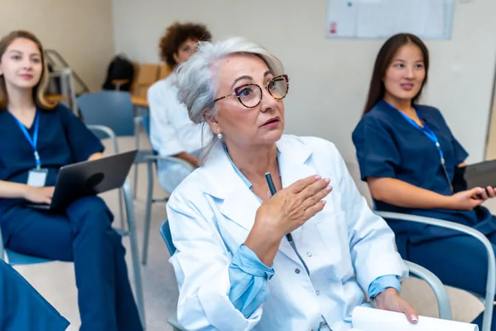 An instructor supporting mature career change students in a classroom setting.