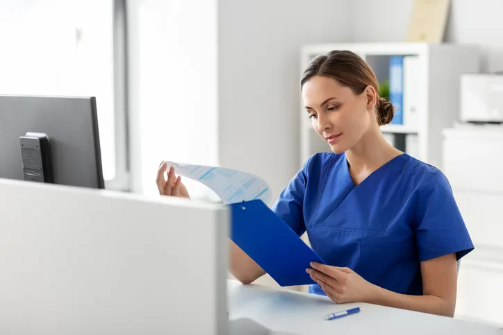 LPN reviewing patient chart and documentation during a shift.